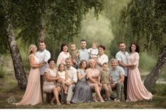 a family posing for a photo in front of some trees