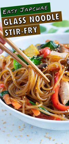 a close up of a plate of noodles with chopsticks