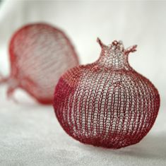 two red mesh objects sitting on top of a white surface