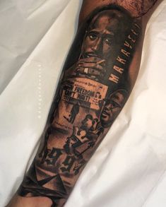 a man's arm with a black and grey tattoo on it that has an image of two men