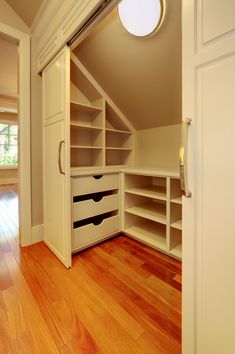 an image of a closet with shelves and drawers