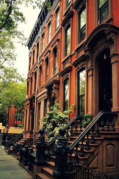 an apartment building with many windows and balconies on the side walk next to it