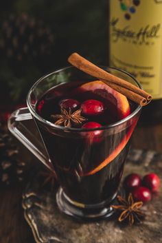 a glass mug filled with fruit and spices