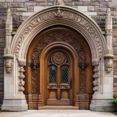 an ornate wooden door in front of a stone building