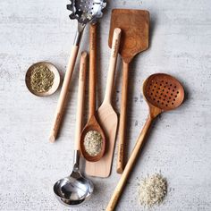 wooden spoons and other kitchen utensils on a table