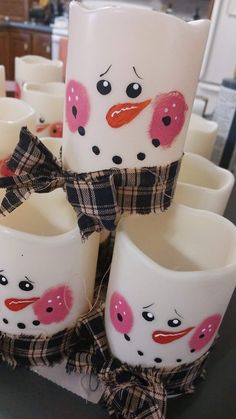 some white cups with pink and black designs on them are stacked up next to each other