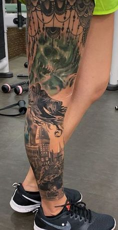 a person with a tattoo on their leg and some sort of animal in the background