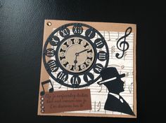 an altered clock with music notes and a man's silhouette on the face is shown