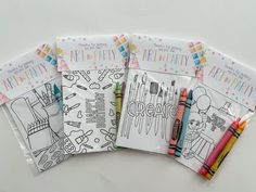 four coloring books with crayons and markers