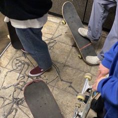 several people standing around with skateboards on the ground