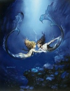 two mermaids swimming in the ocean with their tails touching each other's chests