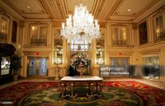 a chandelier hangs from the ceiling in an ornately decorated lobby news photo