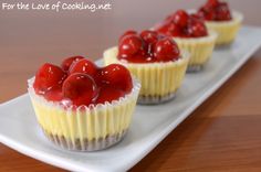 small cupcakes with cherries are on a white plate