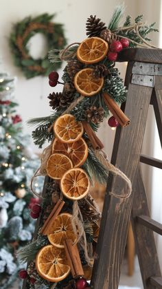 an old ladder is decorated with orange slices and cinnamons for the holiday seasoning