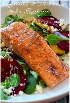 a white plate topped with salmon and vegetables