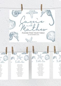 wedding seating chart with sea shells and starfishs on clothes pins hanging from pegs