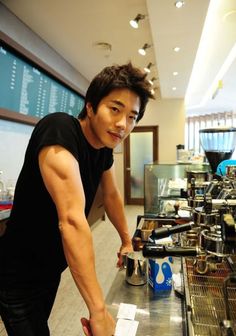 a man standing next to a counter in a restaurant