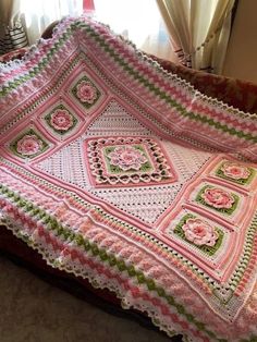 a crocheted blanket is sitting on a couch