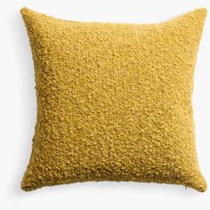 a yellow pillow on a white background