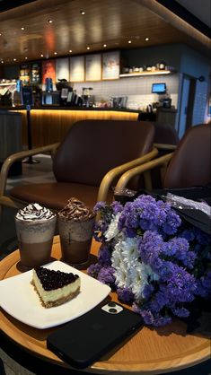 two desserts are sitting on a table with purple flowers