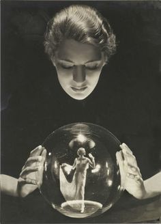 a woman holding a crystal ball in her hands