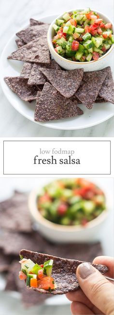 a person holding a tortilla chip in front of a bowl of fresh salsa