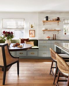 the kitchen is clean and ready to be used for dinner or lunchtime, with wicker chairs