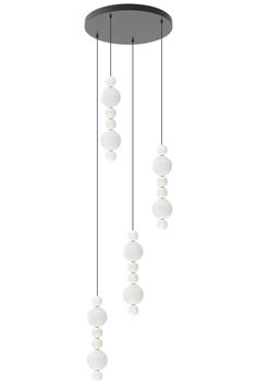 three white balls hanging from the ceiling