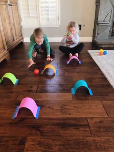 two children playing with toys on the floor