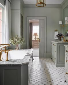 the bathroom is decorated in shades of gray and white, with gold accents on the walls