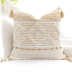 a white couch with a decorative pillow on it