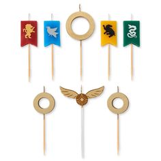 a set of four wooden toothpicks with different colored flags and animals on them