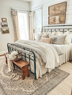 a bed room with a neatly made bed next to a window and a rug on the floor