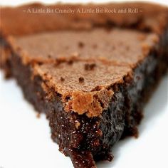 a slice of chocolate cake on a white plate with the words, a little bit crunchy a little bit rock and roll