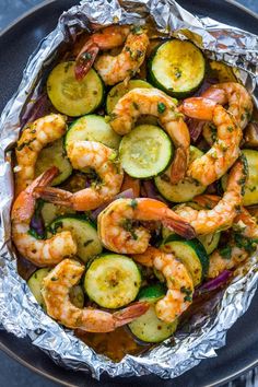 grilled shrimp and zucchini in foil on a plate