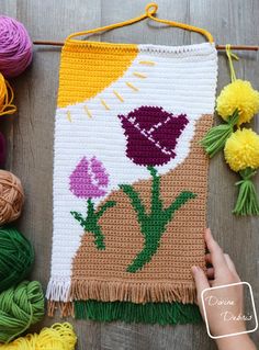 a crochet project with flowers and yarn