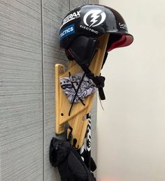 a helmet and skis are hanging on the wall