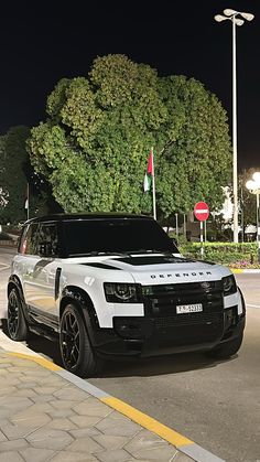 a white and black car parked on the street