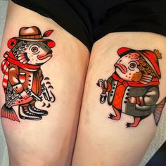 two fish tattoos on both thighs with hats and scarves, one is holding a fishing hook