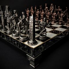 a chess board with some metal figures on it