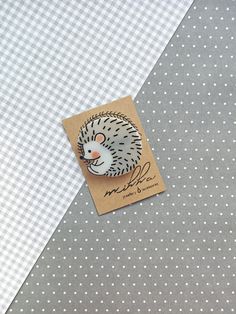 a card with a hedgehog on it sitting next to a polka dot table cloth