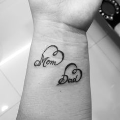 a woman's wrist tattoo with the word mom and baby on it