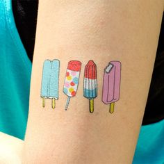 three ice cream pops on the left side of the arm, one with candy and one with lollipops