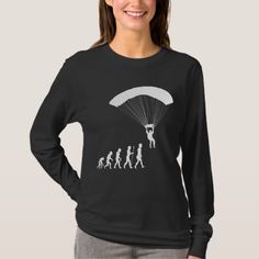 a woman wearing a black shirt with an image of people parachuting