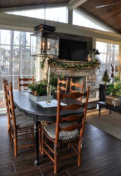 a living room filled with furniture and a flat screen tv mounted above a fire place