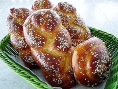 several loaves of bread sitting in a green basket