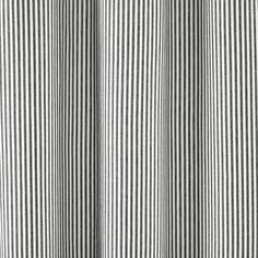 a black and white striped curtain hanging from a window