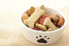 a white bowl filled with dog treats on top of a table