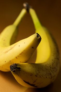 two ripe bananas sitting on top of a table