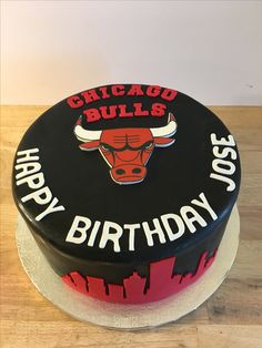 a chicago bulls birthday cake on a wooden table